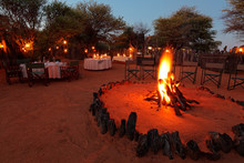 Nighttime Campfire And Decorated Tables For Outdoor Safari Catering .