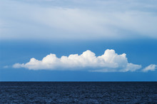 Blue Sky With White Cumulus Cloud Over The Baltic Sea. Pomerania, Poland.