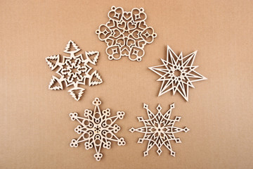 Wall Mural - Laser cut wood snowflakes ornaments.  Wooden snowflakes on carton.