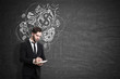 © ImageFlow - Man with notebook near dollar signs, blackboard
