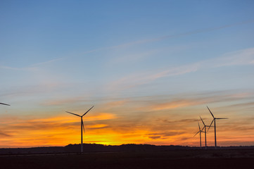 Wall Mural - Silhouette of wind turbine on sunset