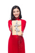 Vietnamese young woman in Ao Dai dress holding gift box.