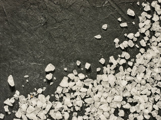 Wall Mural - coarse sea salt on dark background close up