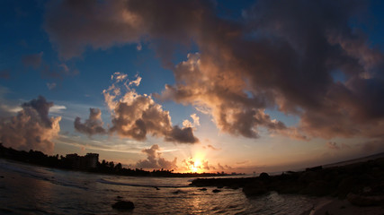 Wall Mural - Caribbean tropical waterfront in clouds - sunset over sea