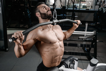 Fitness instructor handsome man in the gym gain muscle