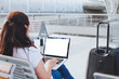 © Song_about_summer - woman using laptop computer in the airport, banking online or web check-in, passenger looking at empty blank screen