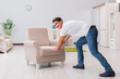 © Elnur - Man moving furniture at home