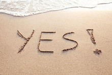 YES Concept, Positive Changes In The Life, Word Written On Sand Beach.