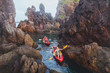 © Song_about_summer - kayaking, adventure travel, group of people on kayaks between cliffs