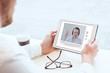 © Song_about_summer - e-learning, video conference, coaching online, man looking at the screen of tablet