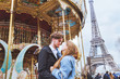 © Song_about_summer - happy couple in Paris, romantic kiss near carousel and Eiffel tower