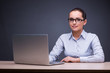 © Elnur - Young businesswoman with laptop at her desk