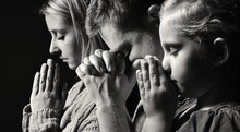 Praying Family. Man, Woman And Child.