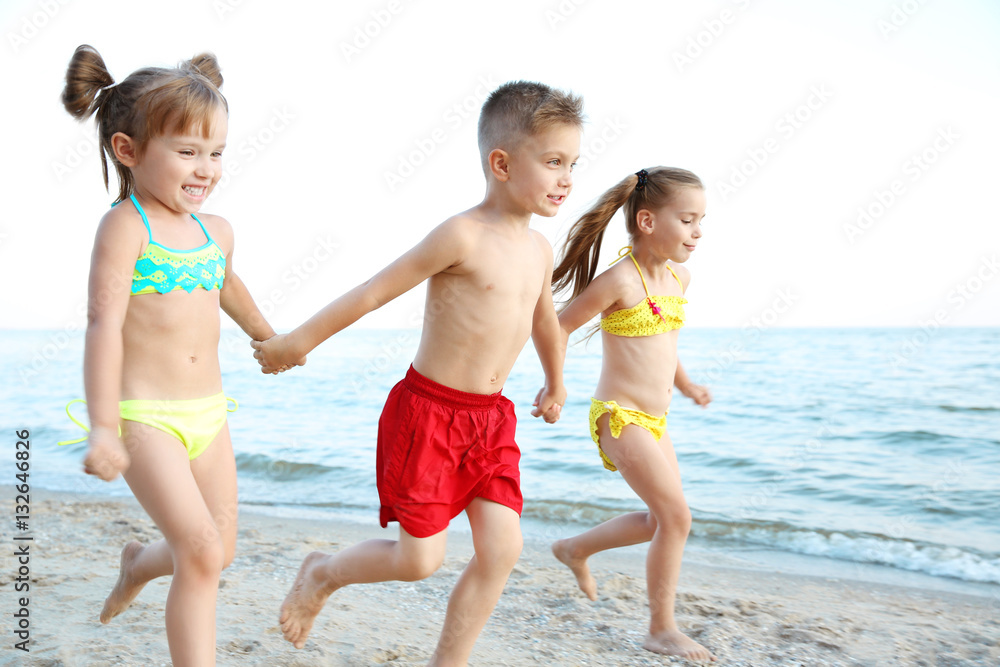 Cute kids having fun on beach