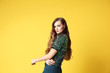 © Africa Studio - Beautiful young woman posing on yellow background