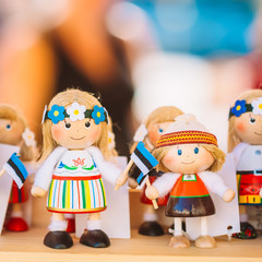 Wall Mural - Souvenirs Ethnic Folk National Wooden Dolls Toys At European Estonian Market