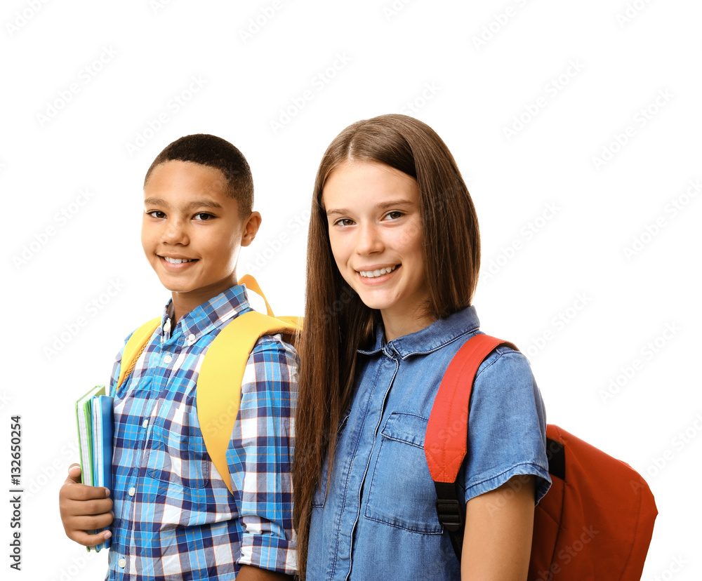 Cheerful teenagers with backpacks holding notebooks on white background