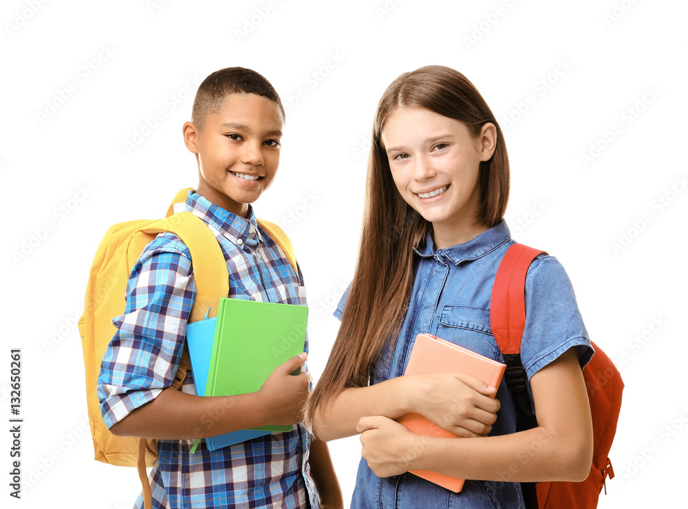 Cheerful teenagers with backpacks holding notebooks on white background