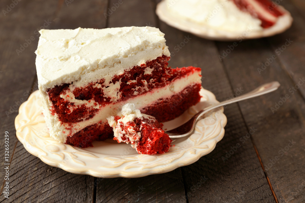 Slice of delicious red velvet cake on plate