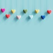 Hanging colorful tiny hearts on pastel blue background. minimal concept idea.