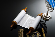 Religion And Judaism Concept With The Holy Torah And A Menorah. The Torah Is The Jewish Holy Text / Book And A Menorah Is The Traditional Branched Candle Stick Specific To Hanukkah