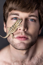 Portrait Of A Young Handsome Man With Lizard On His Face