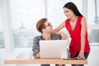 © Drobot Dean - Smiling Woman standing near man by the table in office