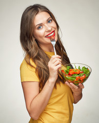 Wall Mural - toothy smiling woman eating vegatable salad with glass bowl.