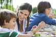 © PhotoAlto - Family enjoying meal outdoors