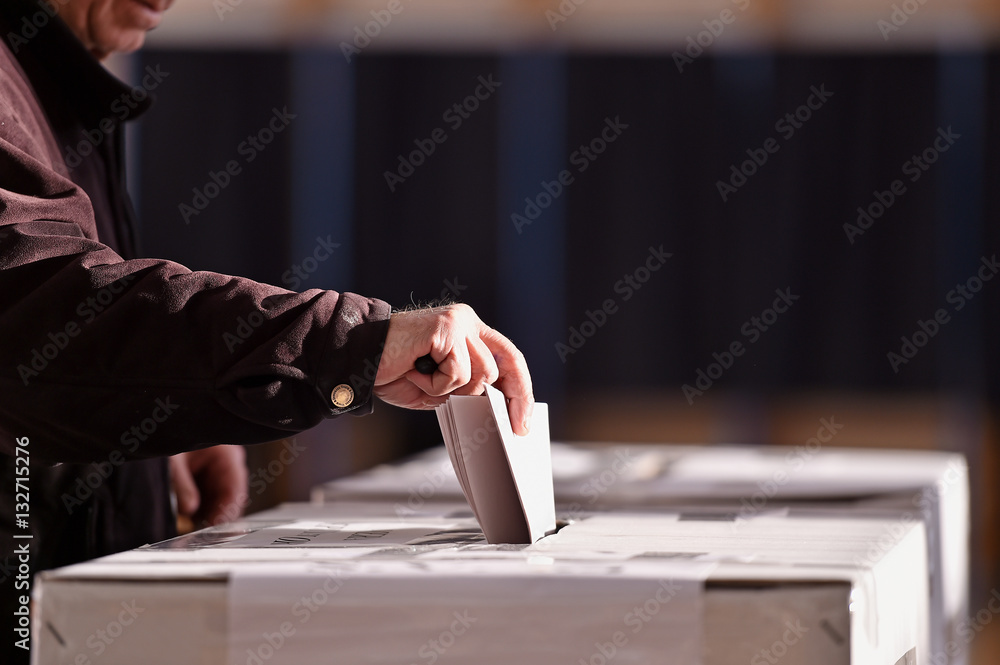 Person casting vote into ballot box Stock Photo | Adobe Stock