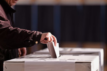 Person Casting Vote Into Ballot Box