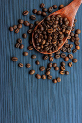 Wall Mural - Coffee beans and wood spoon on dark wood background