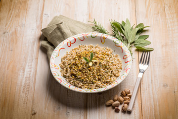 Canvas Print - barley risotto with herbs and pistachio nuts