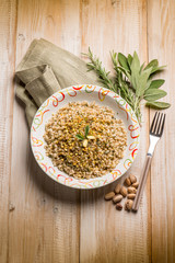 Canvas Print - barley risotto with herbs and pistachio nuts