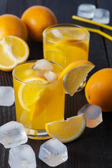 Two glasses with orange beverage on the wooden table