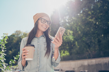 Poster - Portrait of beautiful hipster woman  reading message in the park