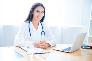 Wall Mural - Portrait of cheerful happy female doctor on consultation