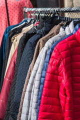 Winter clothes hanging at a store