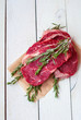 Beef raw steaks on a rough background