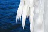 Fototapeta Panele - Large icicles on a background of the sea. Ice storm