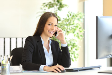 executive calling on phone and looking at camera