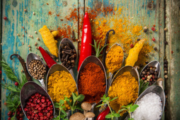 Various colorful spices on wooden table