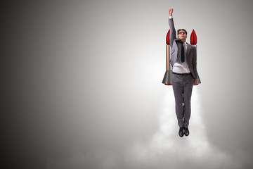 Man flying with the rocket in business concept