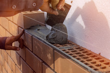 Bricklayer Lays The Mortar For Laying Brick. Construction Work