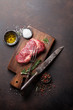 Raw ribeye beef steak cooking with ingredients