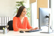© Antonioguillem - Businesswoman working typing in a desktop computer