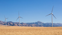 Windmills In Front Of Granite Peak In Utah