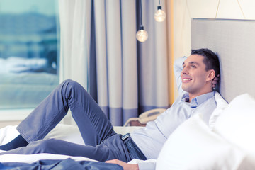 Sticker - happy businesswoman lying in bed in hotel room