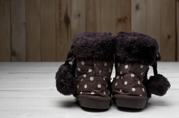 old or secondhand children brown fur boots shoes back side with