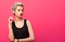 Girl With Short Blond Dyed Hair Over Pink Background